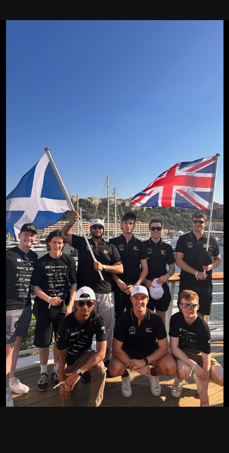 The crew with the Saltire and Union Jack on deck in Monaco